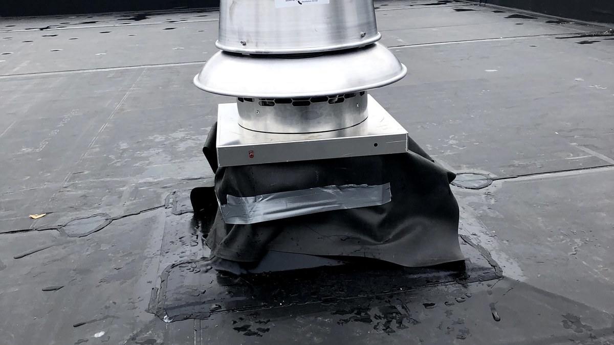 Commercial rooftop exhaust fan mounted on a flat roof.